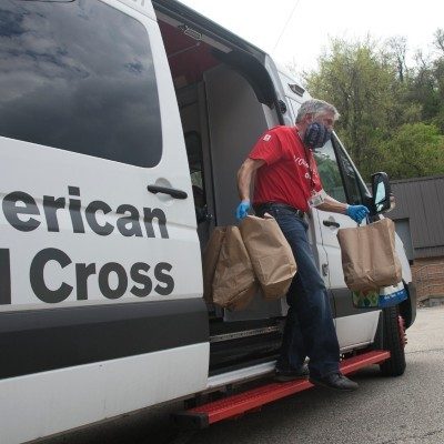 A Red Cross volunteer delivers food after a disaster