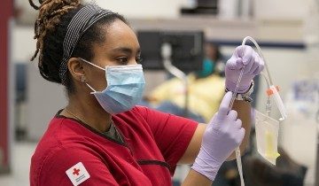 Red Cross phlebotomist examining her gear