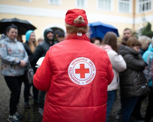 image of a back view of an international red cross volunteer showing their jacket with the red cross symbol